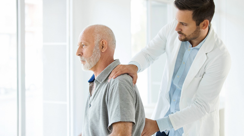Doctor-examining-an-older-patient-with-lower-back-pain