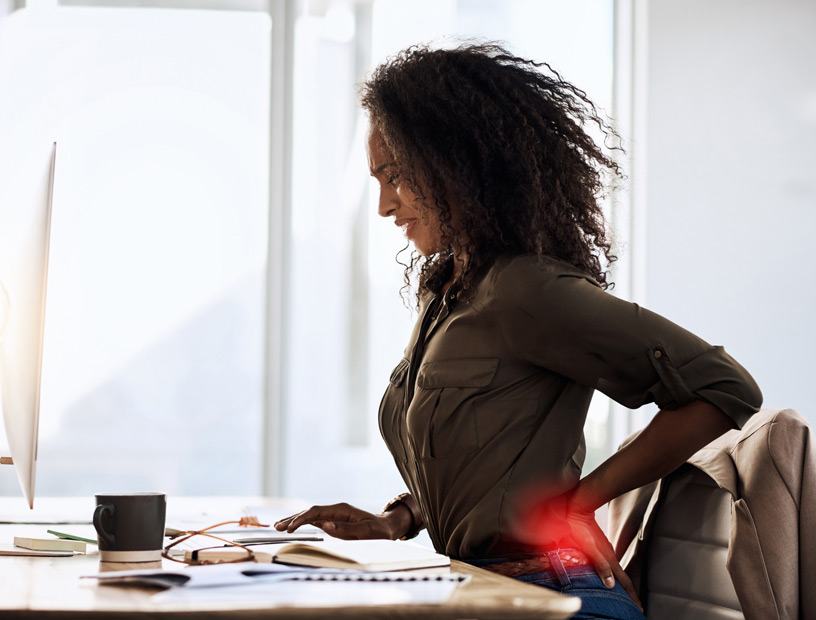 Woman-sitting-at-desk-with-back-pain