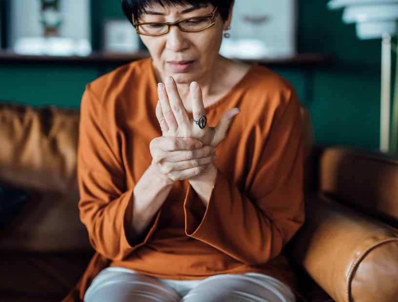 woman-rubbing-her-hands-in-discomfort